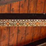...dotato di capriate decorate da una successione di cerchi con temi floreali stilizzati che riprendono la fantasia �a dente di lupo� dell�esterno